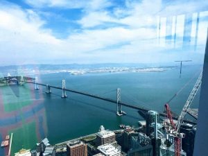 Bay bridge facing view from The Salesforce Tower and view from 61st Ohana Floor in Yerba Buena neighborhood of San Francisco by Matt Fuller Jackson Fuller real estate